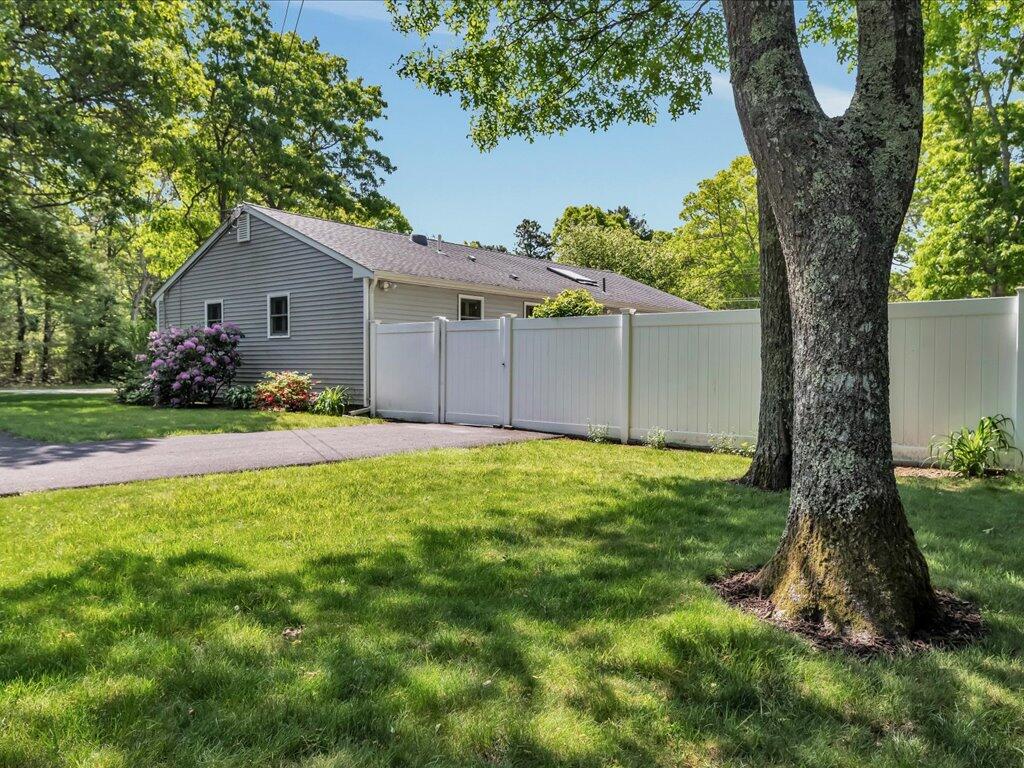 1309 Shootflying Hill Road Centerville, MA 02632 - Photo 41 of 52 a front view of house with yard and green space