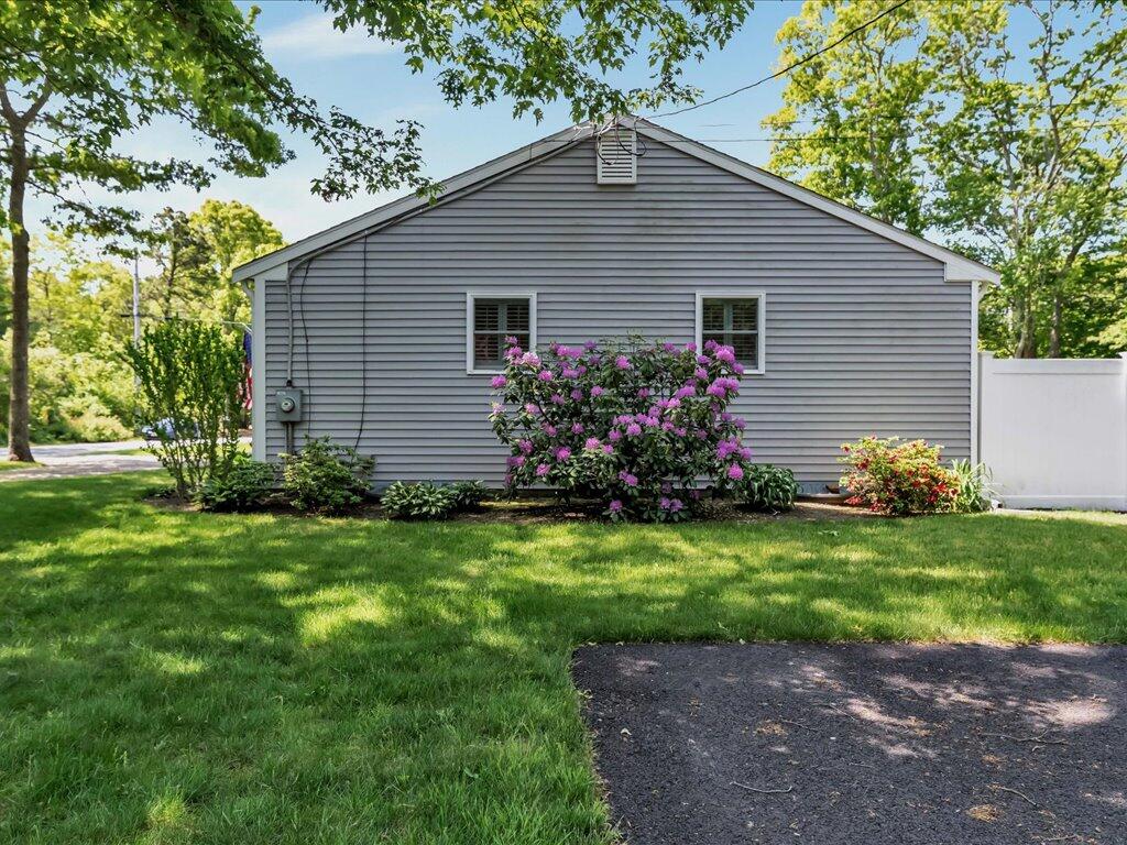 1309 Shootflying Hill Road Centerville, MA 02632 - Photo 42 of 52 a front view of house with yard and green space