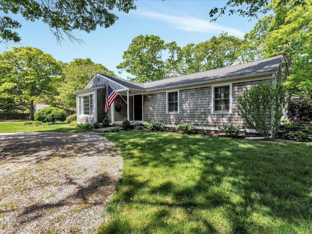 1309 Shootflying Hill Road Centerville, MA 02632 - Photo 44 of 52 a front view of house with yard and green space
