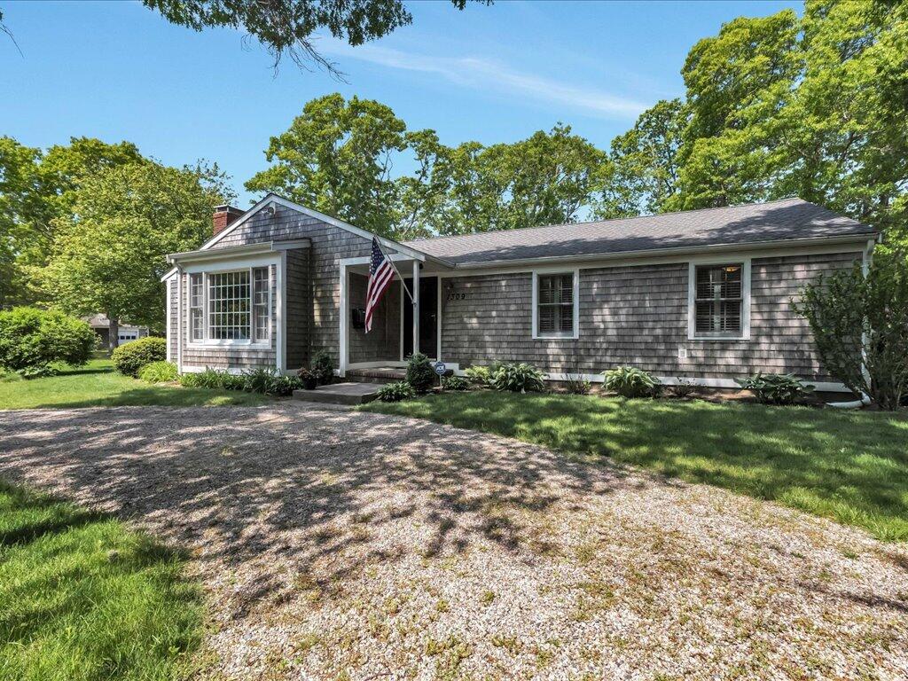 1309 Shootflying Hill Road Centerville, MA 02632 - Photo 45 of 52 a front view of house with yard and green space
