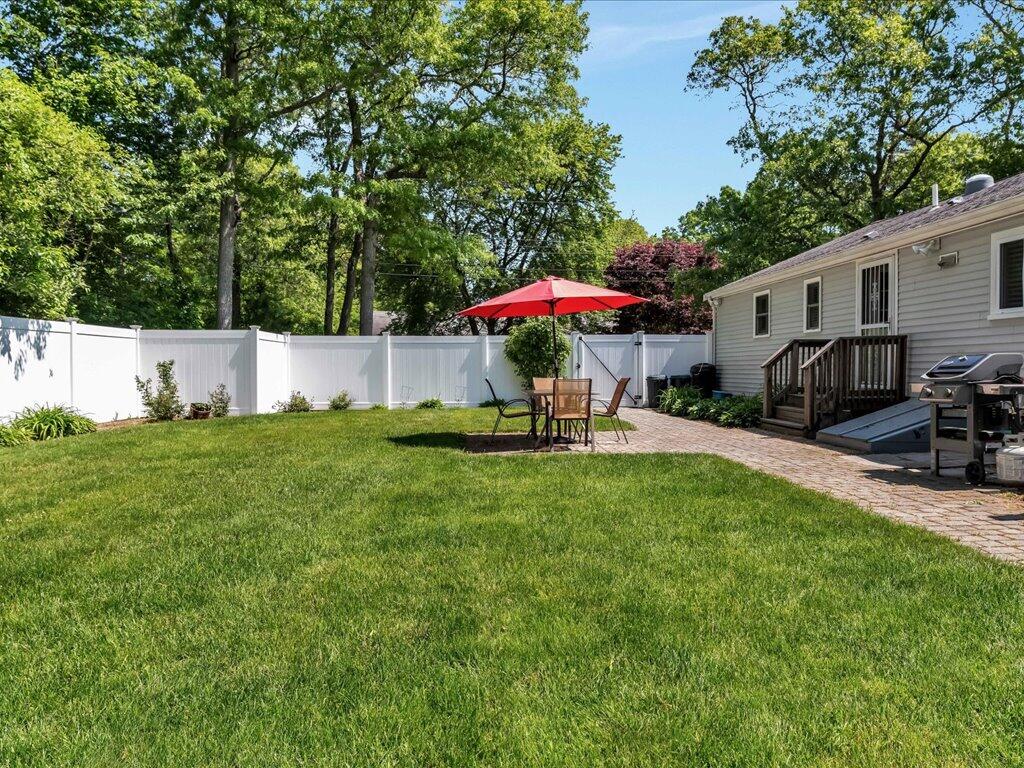 1309 Shootflying Hill Road Centerville, MA 02632 - Photo 47 of 52 a view of a house with backyard and a sitting area