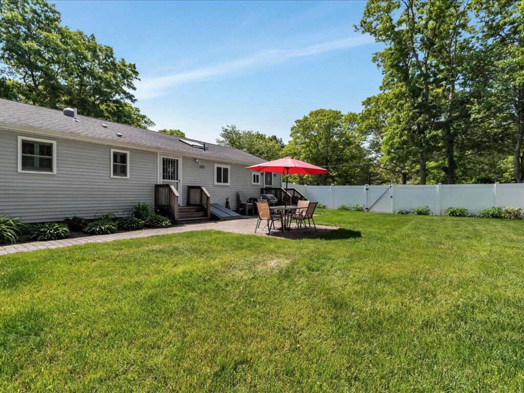 1309 Shootflying Hill Road Centerville, MA 02632 - Photo 48 of 52 a view of a backyard with plants and a patio