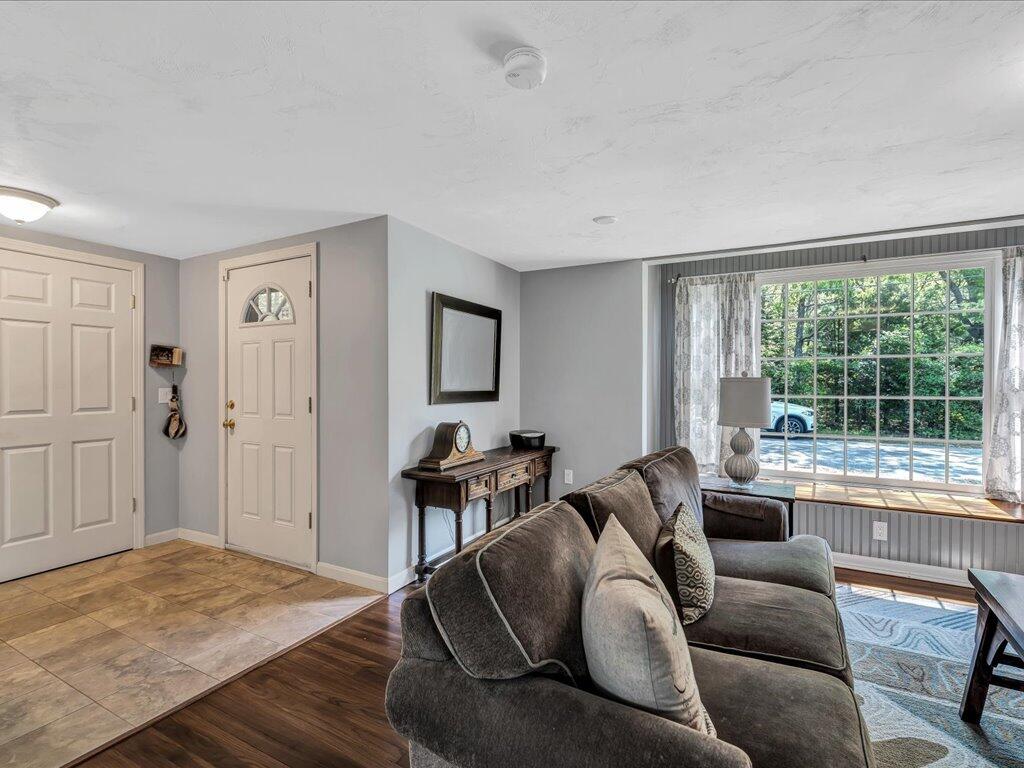 1309 Shootflying Hill Road Centerville, MA 02632 - Photo 5 of 52 a living room with furniture and a large window