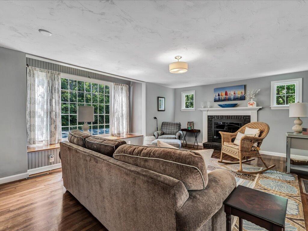 1309 Shootflying Hill Road Centerville, MA 02632 - Photo 7 of 52 a living room with furniture large window and wooden floor