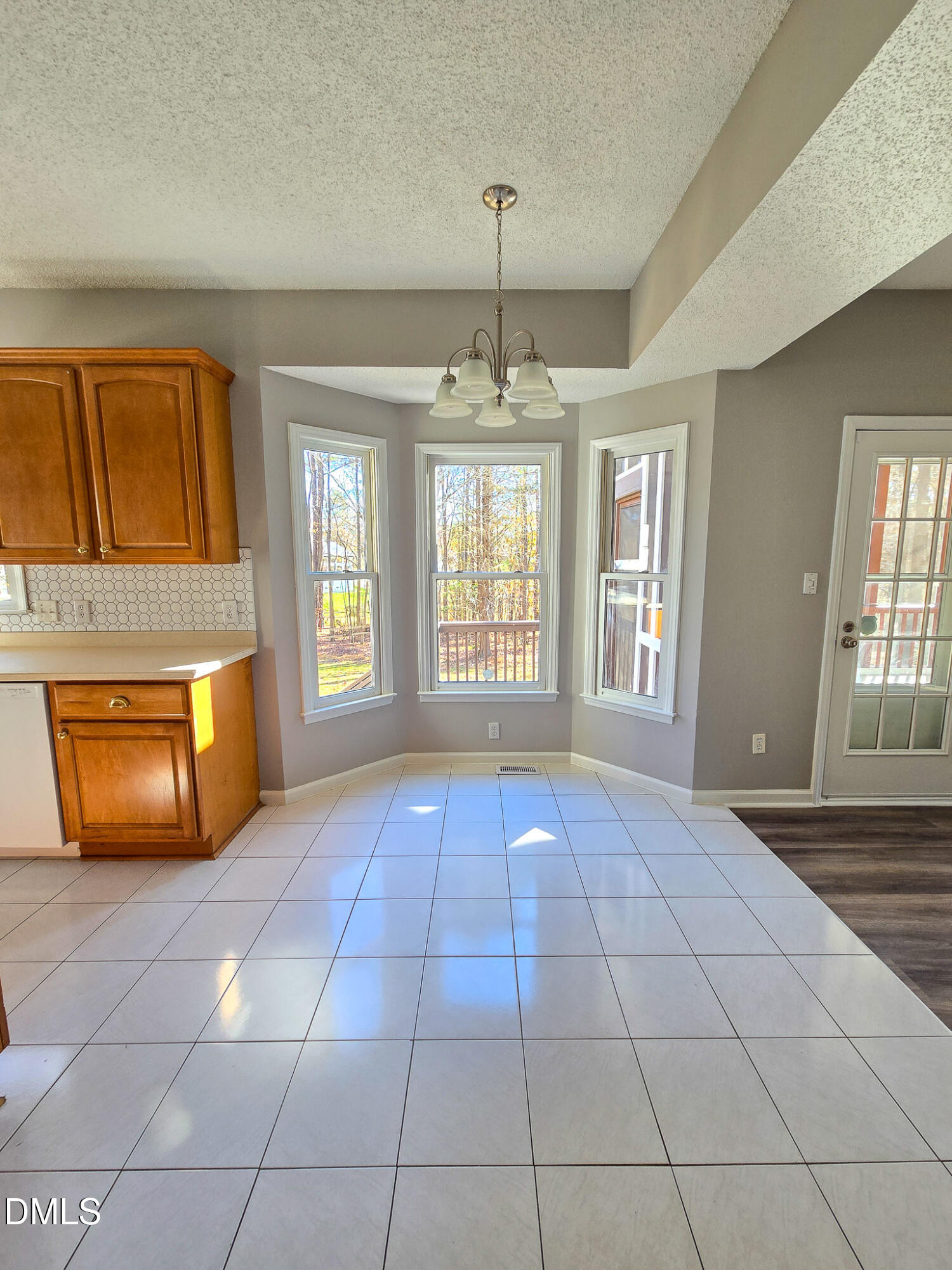 2205 Dungiven Court Garner, NC 27529 - Photo 17 of 66 a view of an empty room with window and chandelier