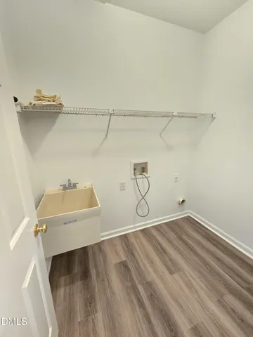 a large white kitchen with wooden floor and glass doors
