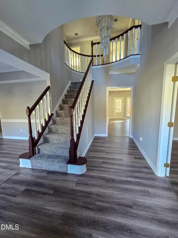 a view of entryway and hall with wooden floor
