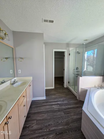 a view of a room with wooden floor and a window