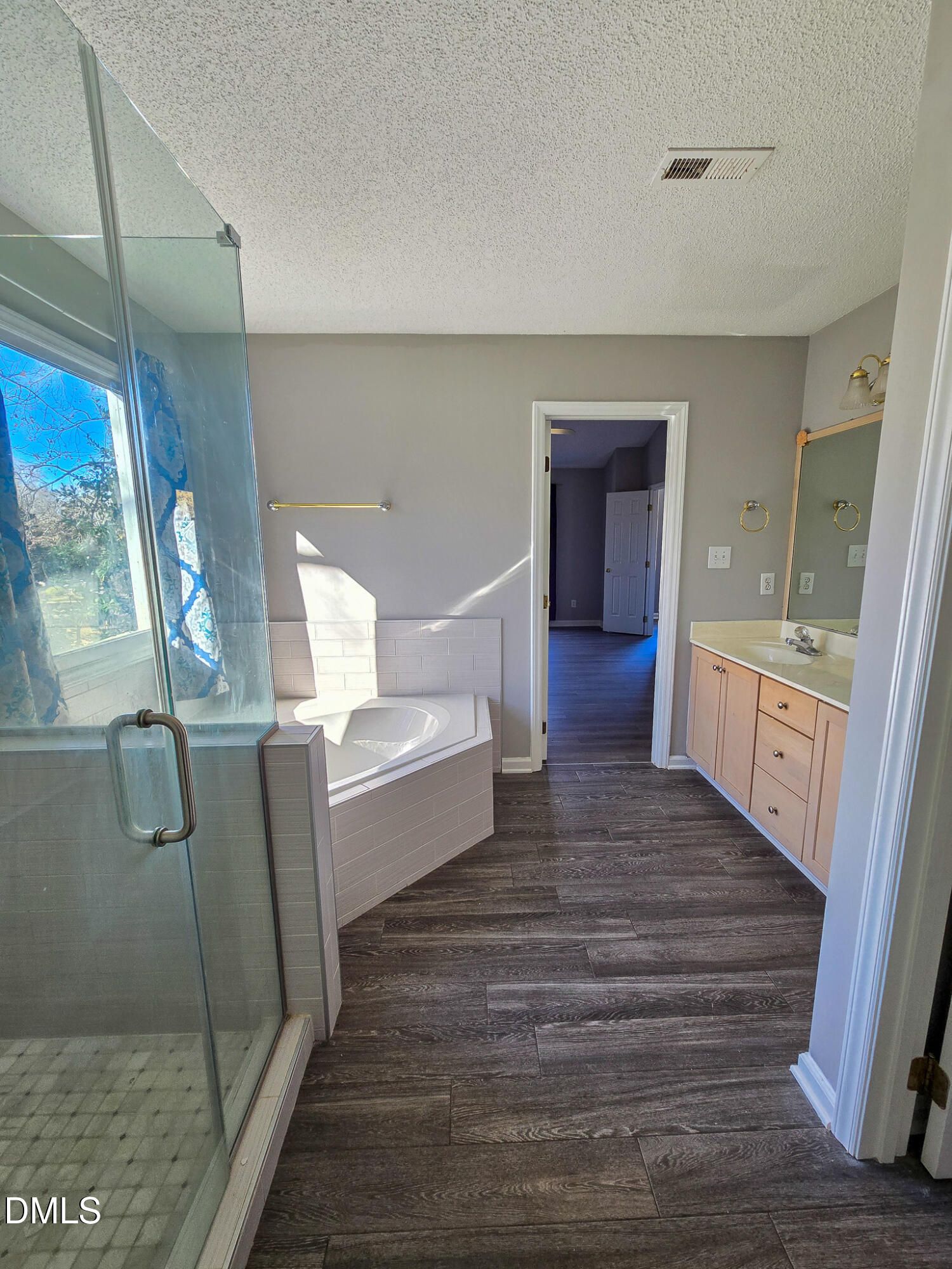 2205 Dungiven Court Garner, NC 27529 - Photo 34 of 66 a bathroom with a bathtub sink and mirror