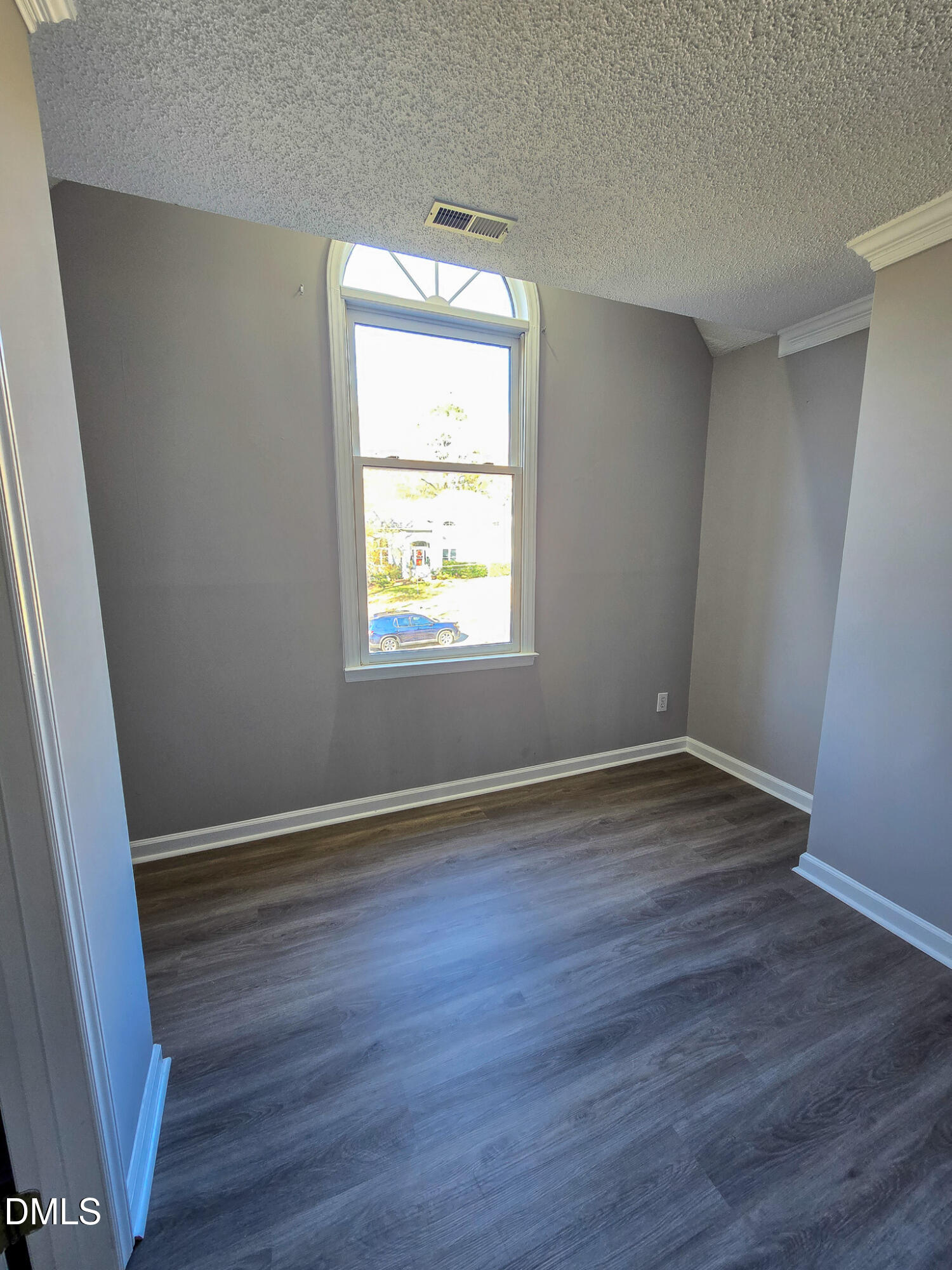 2205 Dungiven Court Garner, NC 27529 - Photo 40 of 66 an empty room with wooden floor and windows