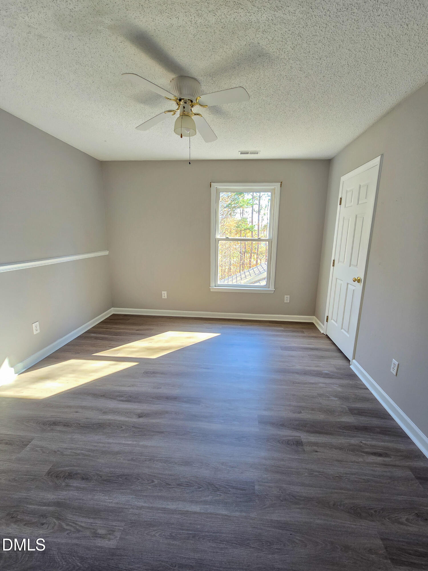 2205 Dungiven Court Garner, NC 27529 - Photo 42 of 66 an empty room with wooden floor and windows