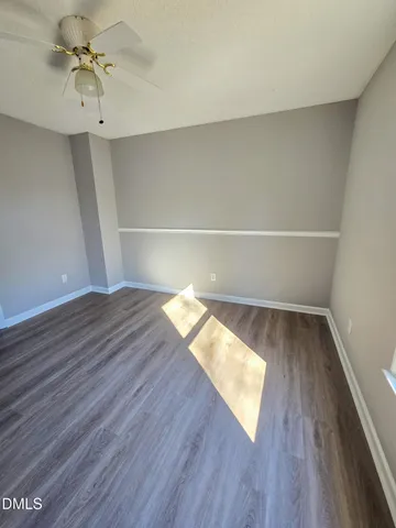 a spacious bathroom with a granite countertop sink a toilet and a mirror