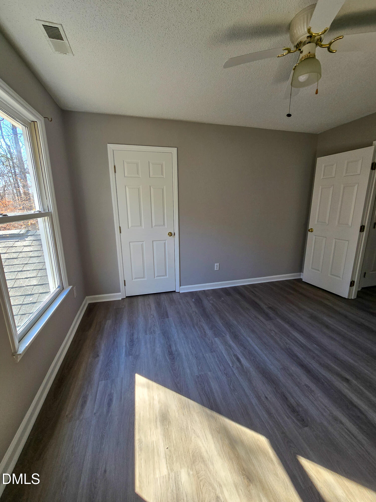 2205 Dungiven Court Garner, NC 27529 - Photo 44 of 66 a view of an empty room with wooden floor and a window