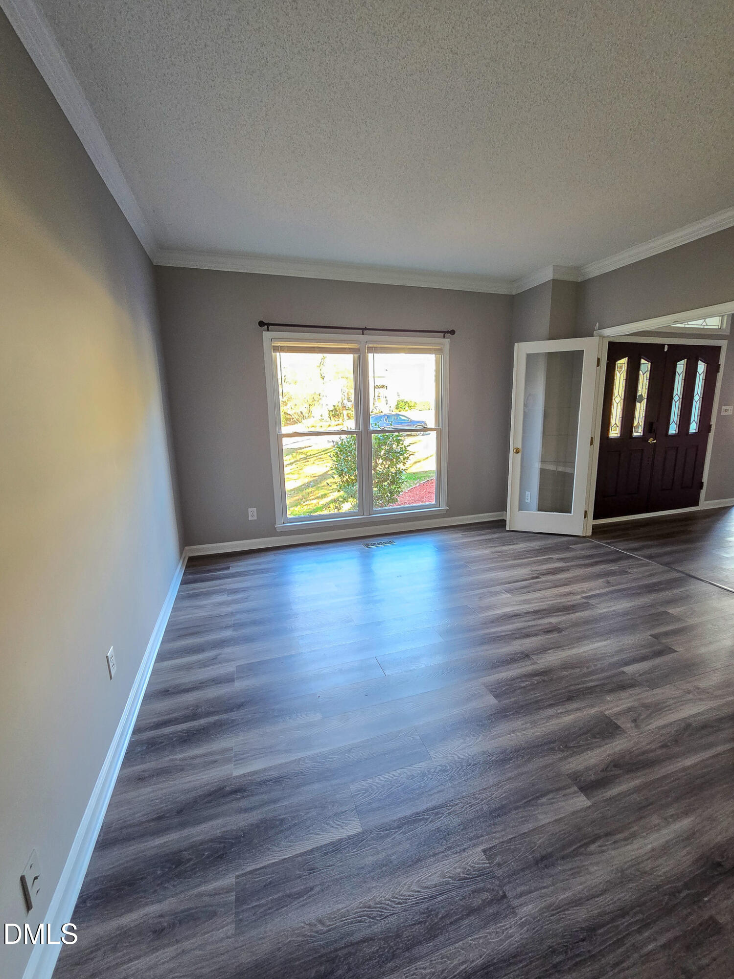 2205 Dungiven Court Garner, NC 27529 - Photo 5 of 66 a view of an empty room with wooden floor and a window