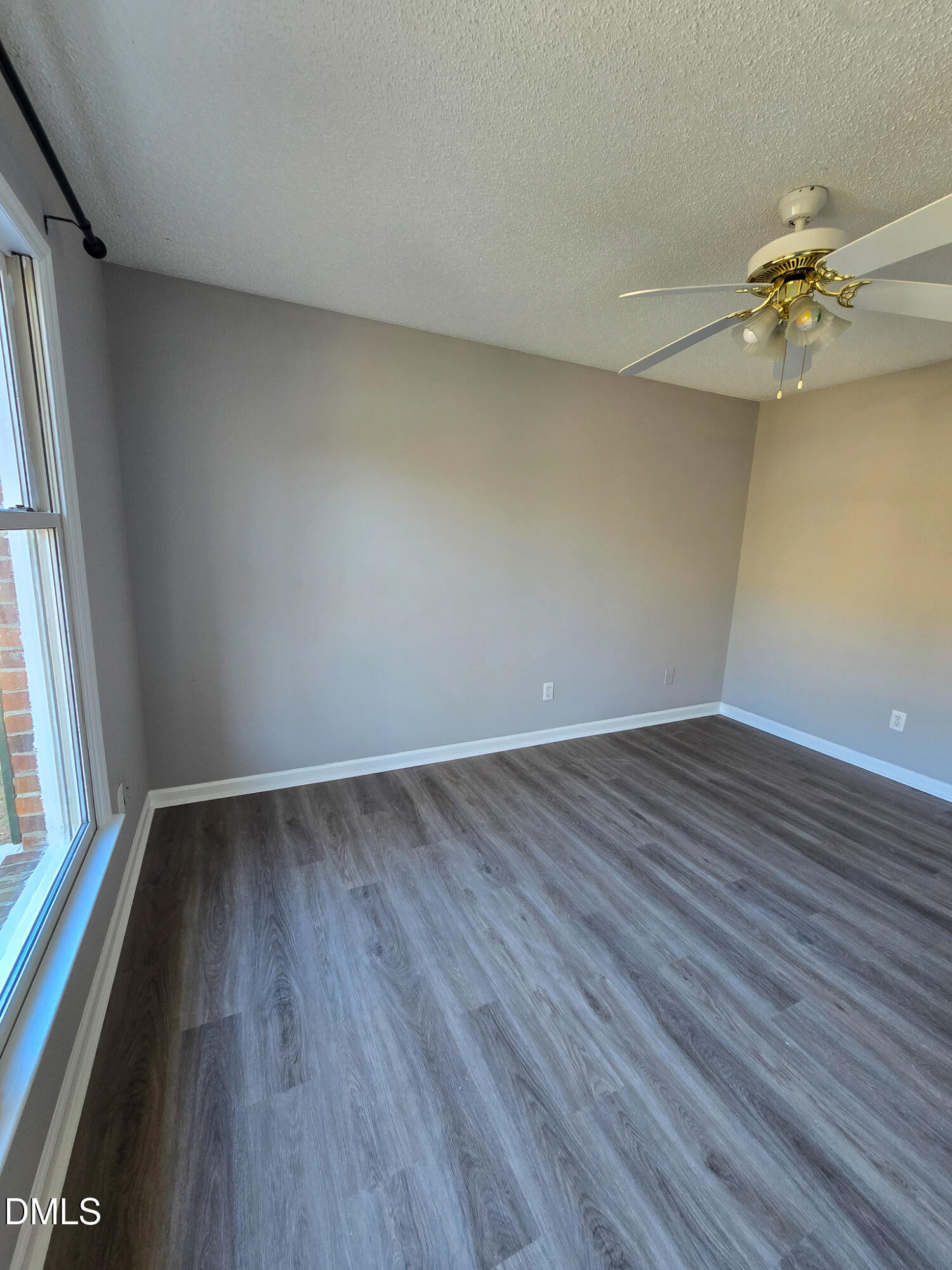 2205 Dungiven Court Garner, NC 27529 - Photo 51 of 66 an empty room with wooden floor and windows