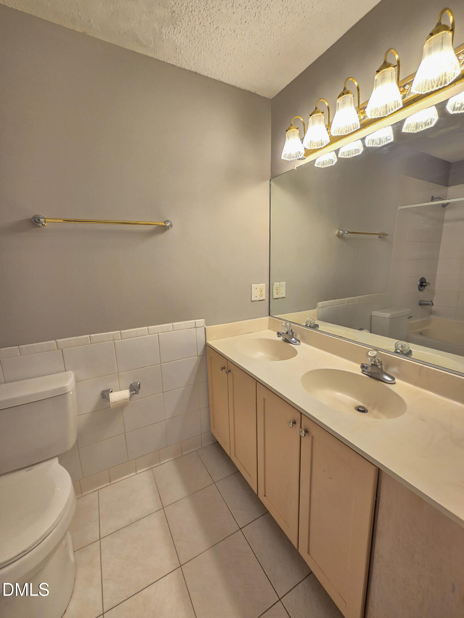 2205 Dungiven Court Garner, NC 27529 - Photo 54 of 66 a spacious bathroom with a granite countertop sink a toilet and a mirror