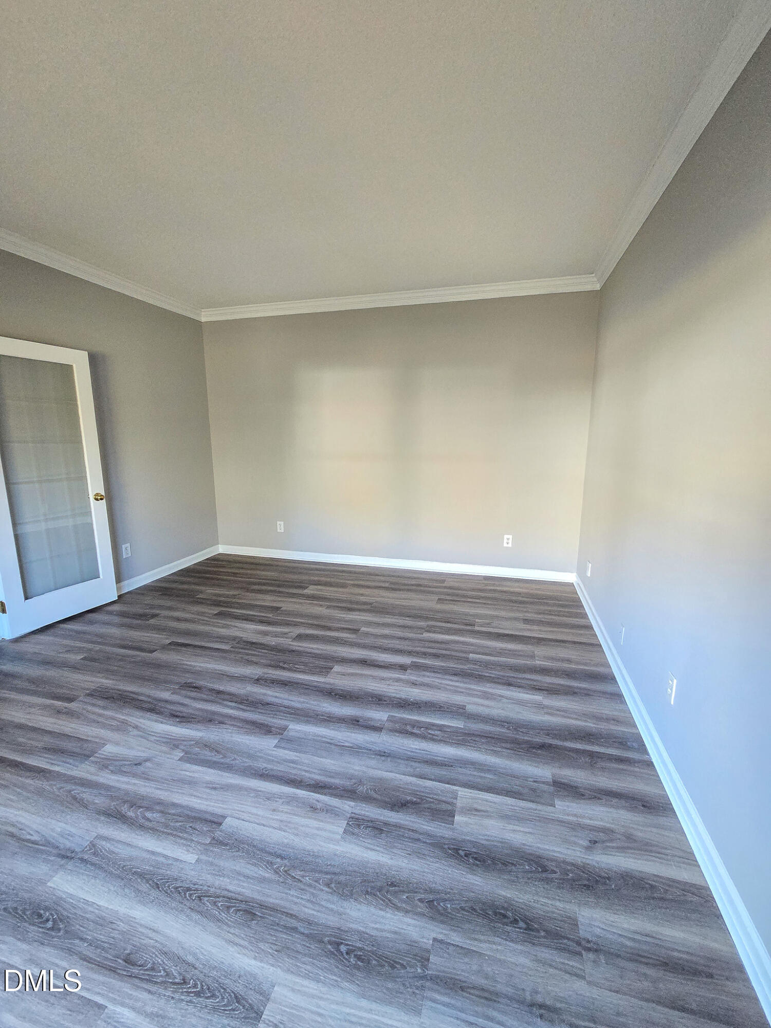 2205 Dungiven Court Garner, NC 27529 - Photo 6 of 66 a view of an empty room with wooden floor and a window
