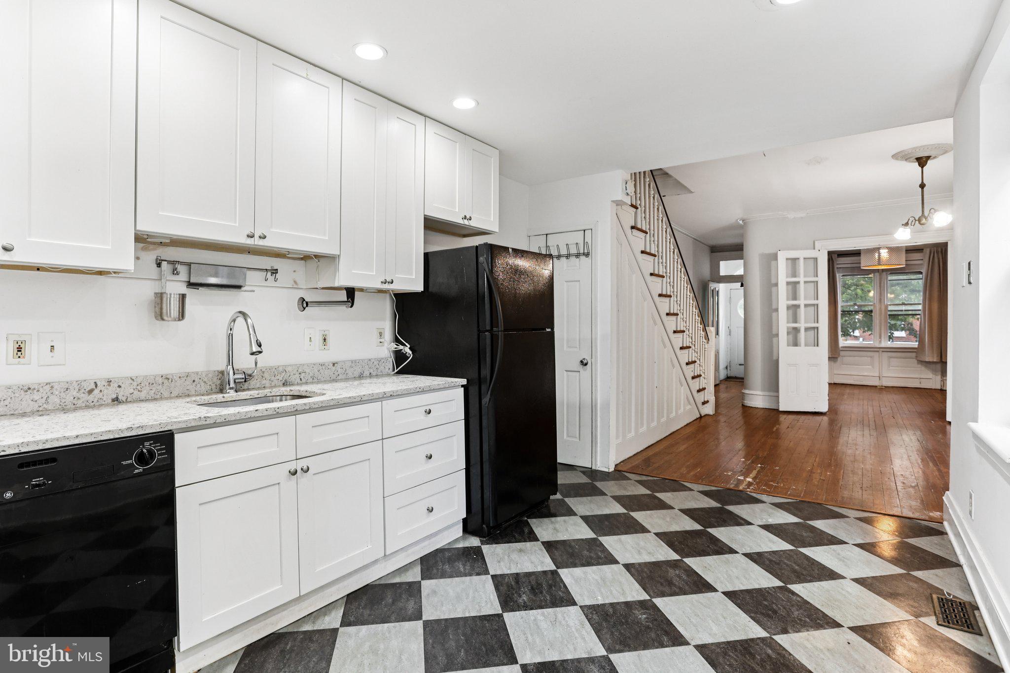 2335 Christian Street Philadelphia, PA 19146 - Photo 11 of 33 a kitchen with a refrigerator a sink and a cabinets
