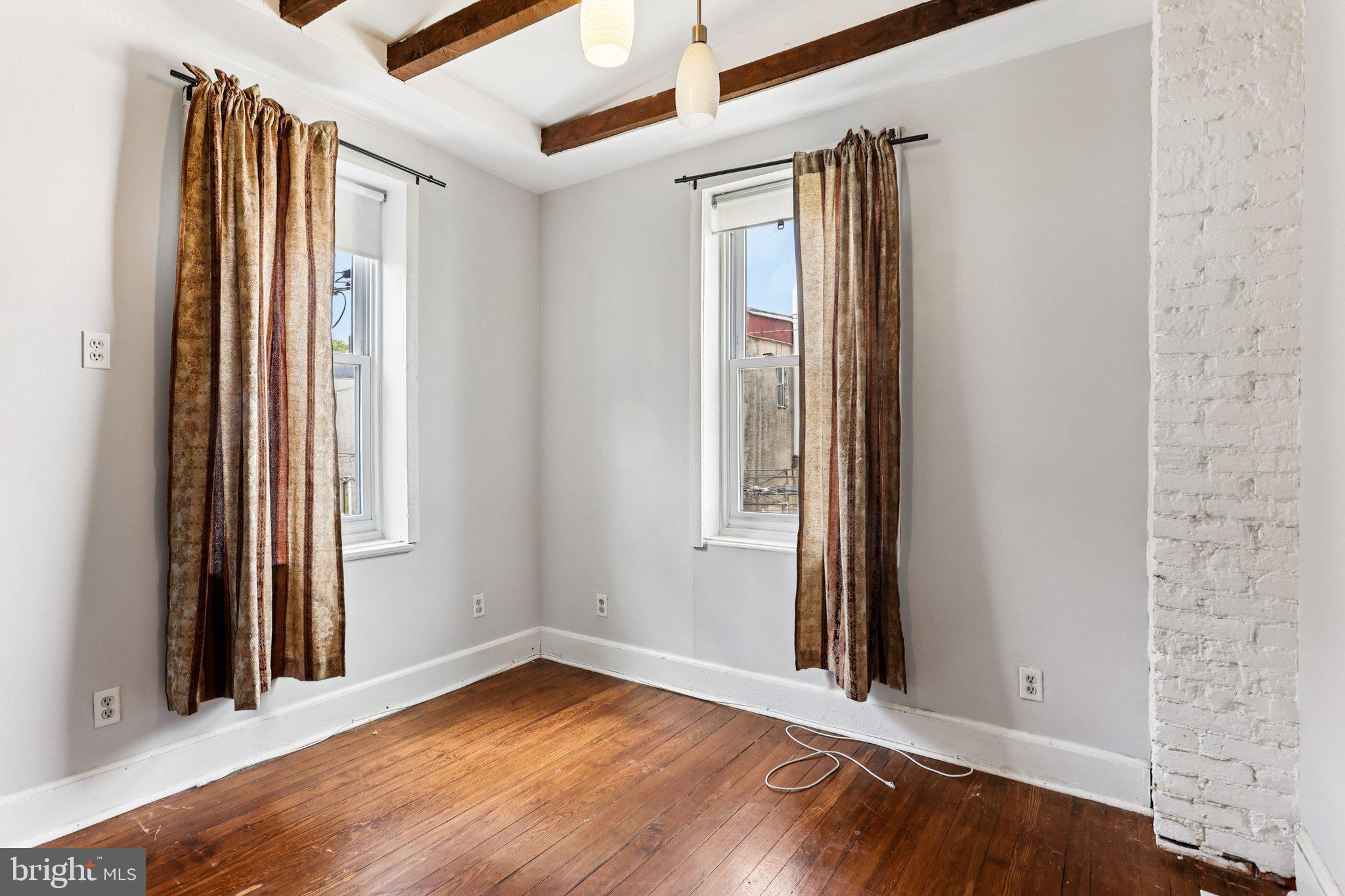 2335 Christian Street Philadelphia, PA 19146 - Photo 12 of 33 an empty room with wooden floor and windows