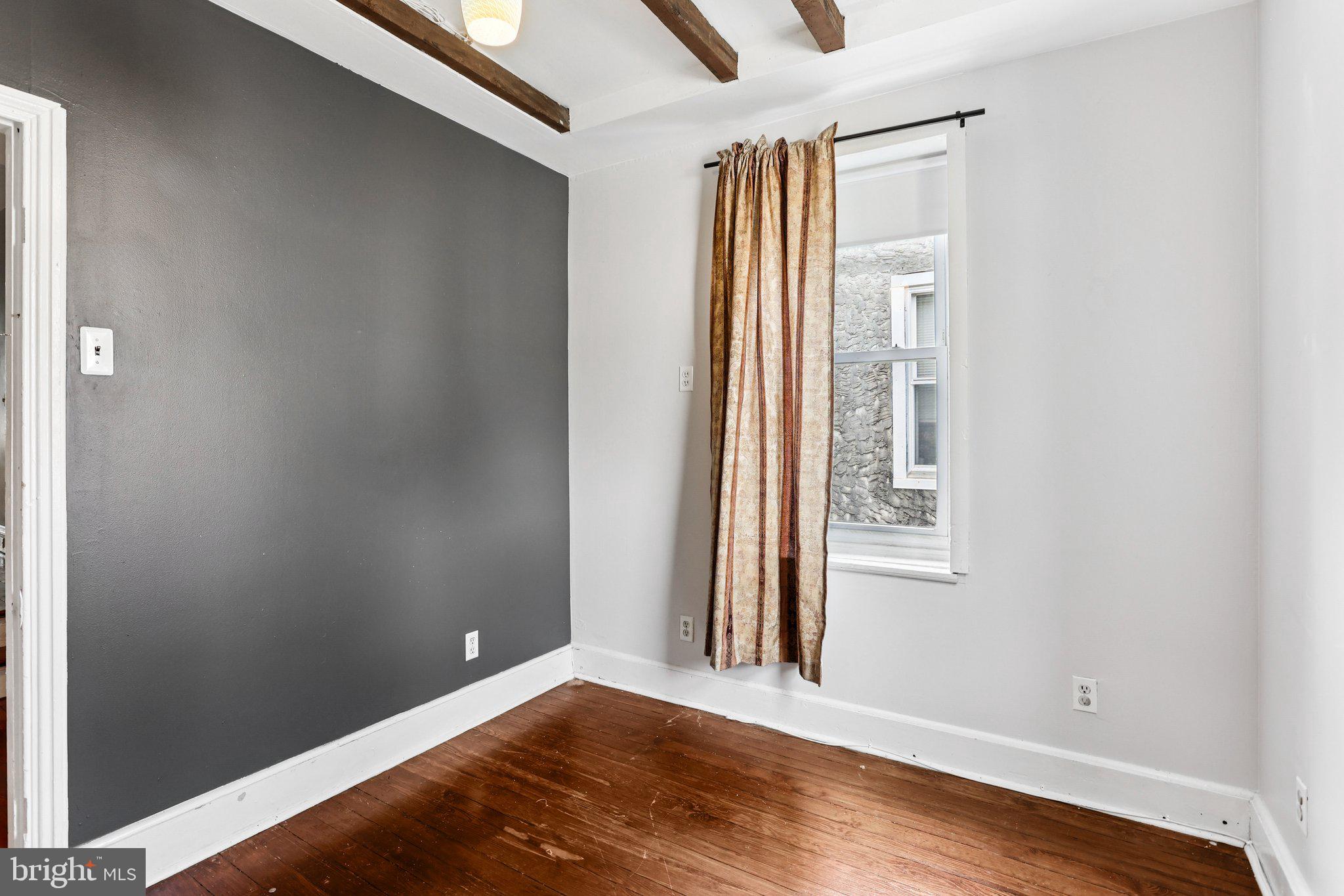 2335 Christian Street Philadelphia, PA 19146 - Photo 13 of 33 an empty room with wooden floor and windows