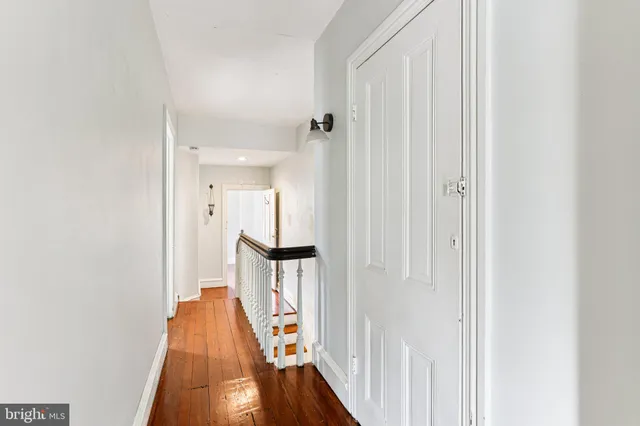 a view of hallway with wooden floor and staircase