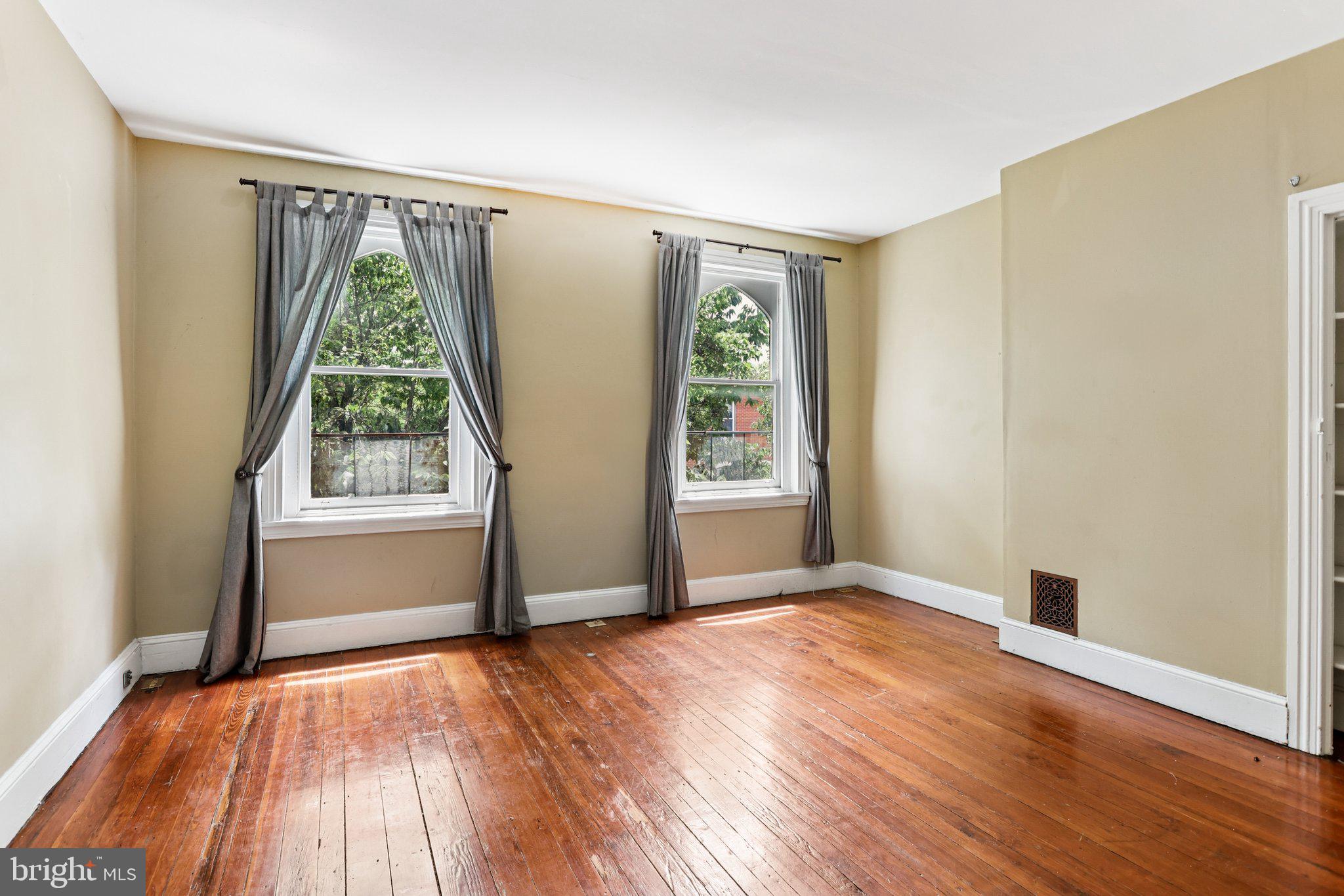 2335 Christian Street Philadelphia, PA 19146 - Photo 21 of 33 an empty room with wooden floor and windows