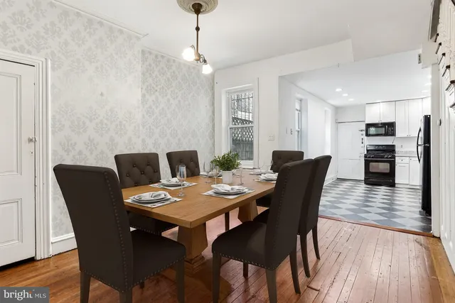 a view of a dining room with furniture wooden floor and chandelier