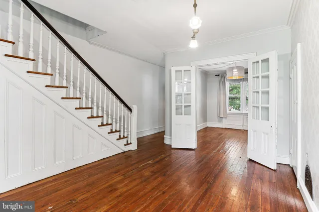 a view of staircase with wooden floor and white walls