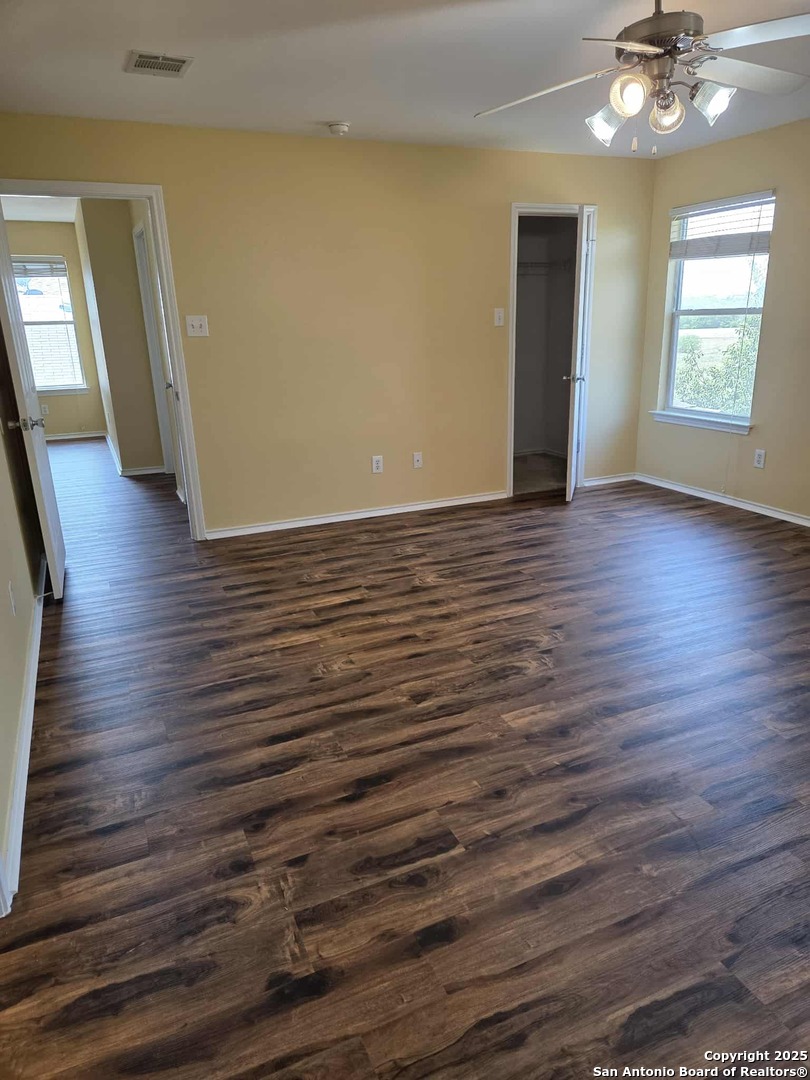 228 Anvil Place Cibolo, TX 78108 - Photo 13 of 21 wooden floor in an empty room with a window