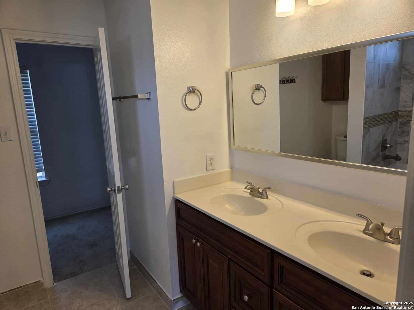 228 Anvil Place Cibolo, TX 78108 - Photo 15 of 21 a bathroom with a double vanity sink and mirror