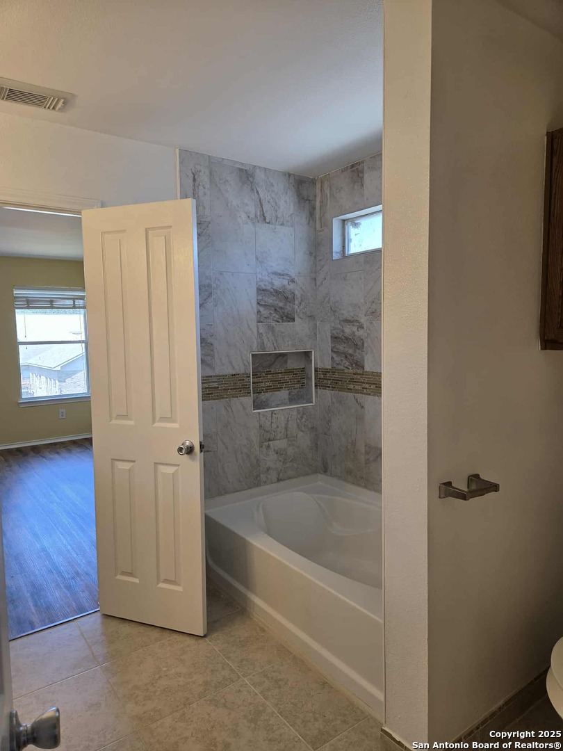 228 Anvil Place Cibolo, TX 78108 - Photo 16 of 21 a bathroom with a bathtub and a shower