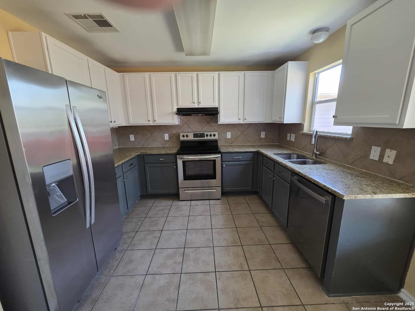 228 Anvil Place Cibolo, TX 78108 - Photo 7 of 21 a kitchen with stainless steel appliances granite countertop a stove a sink a microwave and a refrigerator