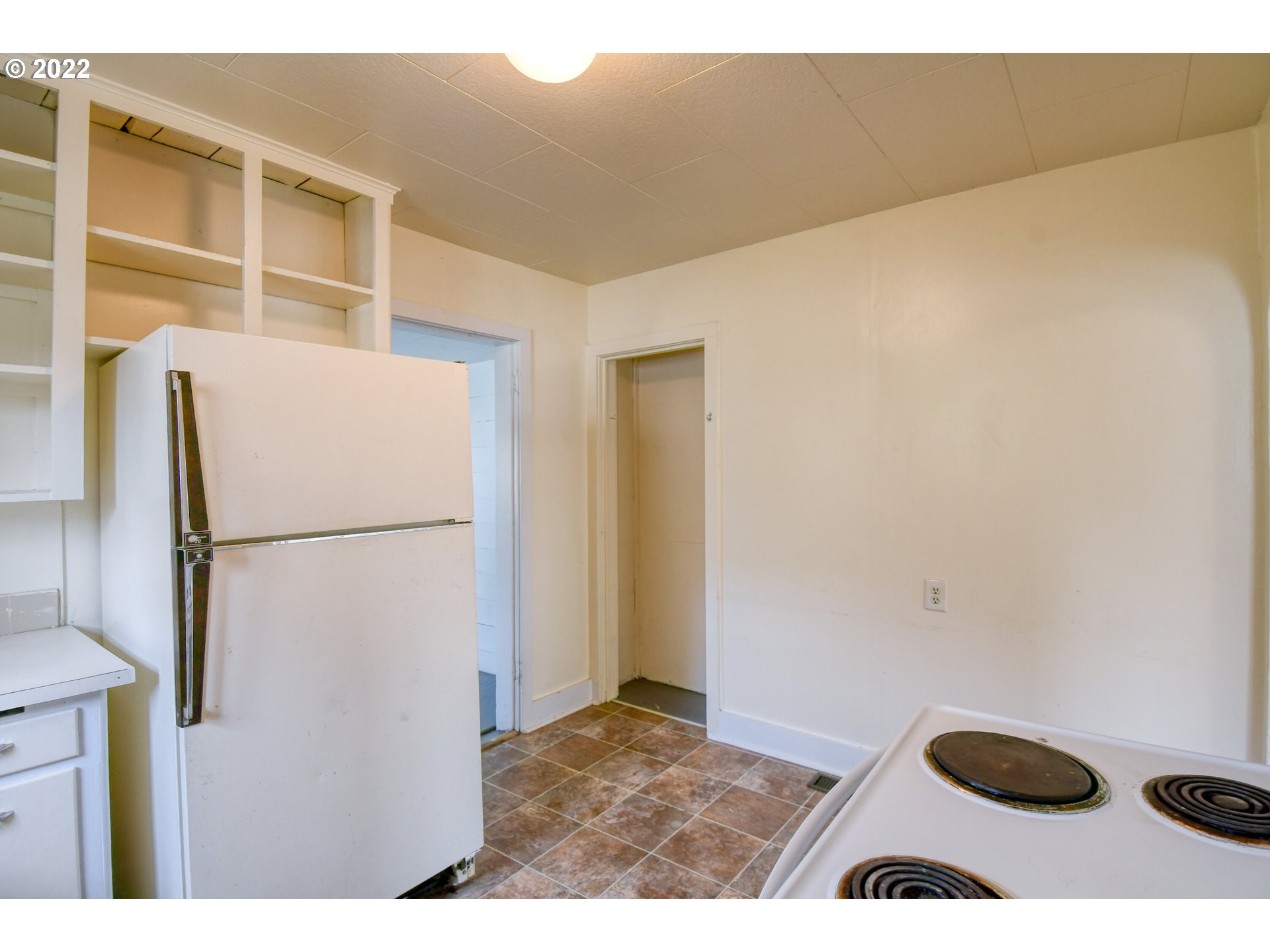 211 West Arch Street Union, OR 97883 - Photo 9 of 32 a view of kitchen with refrigerator and white cabinets