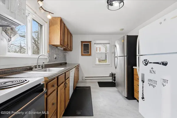 a kitchen with stainless steel appliances granite countertop a sink stove and cabinets