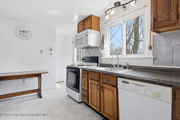 a kitchen with stainless steel appliances a sink a refrigerator and a stove