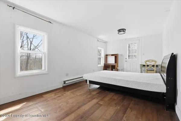 a bathroom with a sink a mirror a toilet and a tub