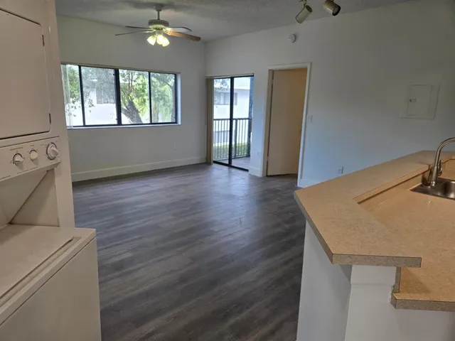 a view of a room that has wooden floor and window