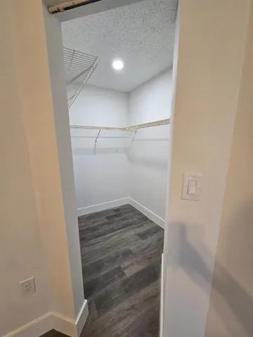a view of storage and utility room with wooden floor