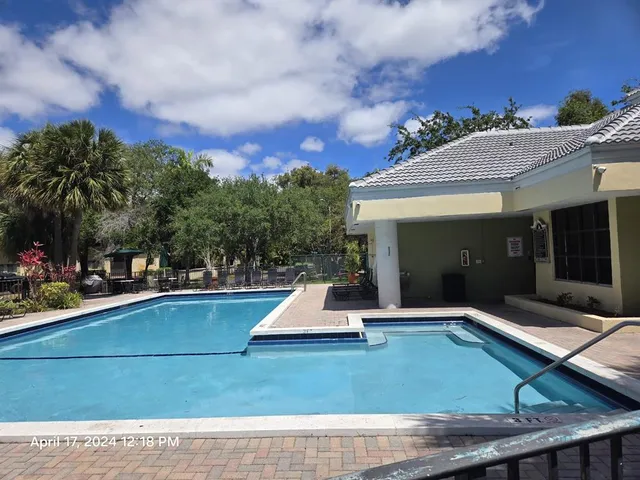 a view of a house with swimming pool and sitting area