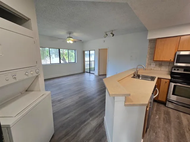 a view of kitchen and sink with wooden floor
