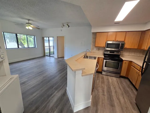 a kitchen that has a sink and a stove top oven