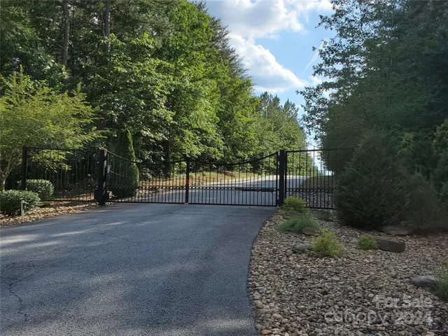 a view of a street with a bench and trees