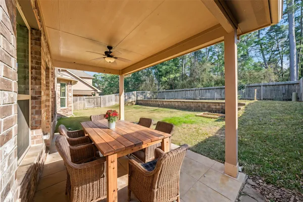 a view of an outdoor dining space with a table and chairs
