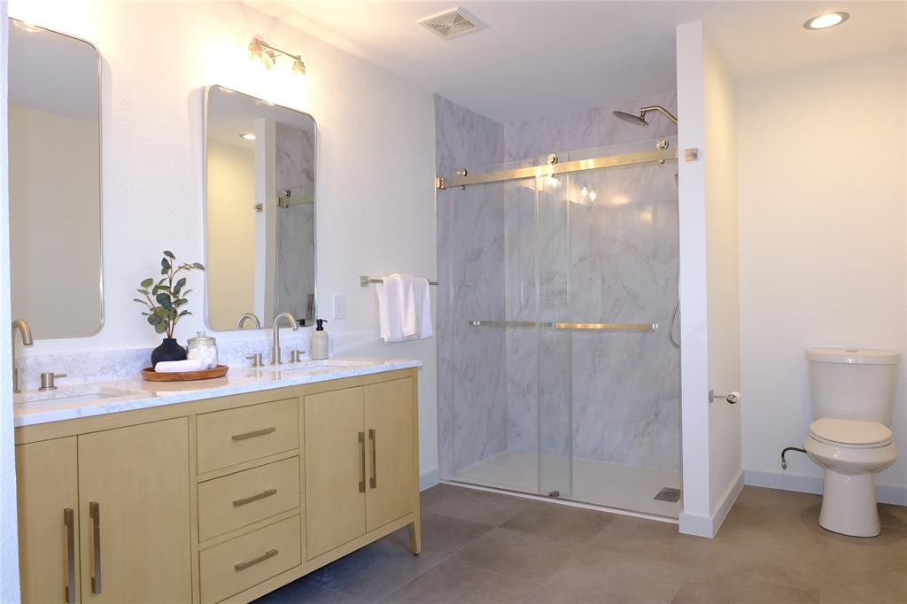 3437 Caprock Ranch Road Fort Worth, TX 76262 - Photo 22 of 27 a bathroom with a double vanity sink toilet and shower