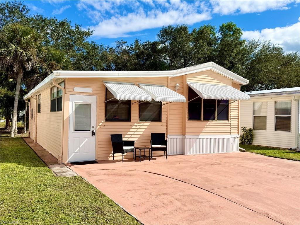 16 Bass Lane, Unit 16 Naples, FL 34114 - Photo 1 of 45 a front view of a house with a garden
