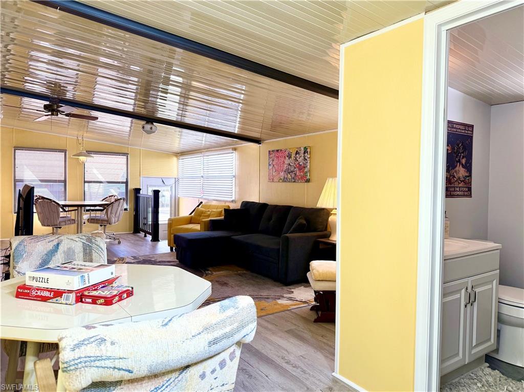 16 Bass Lane, Unit 16 Naples, FL 34114 - Photo 11 of 45 a living room with furniture and a wooden floor