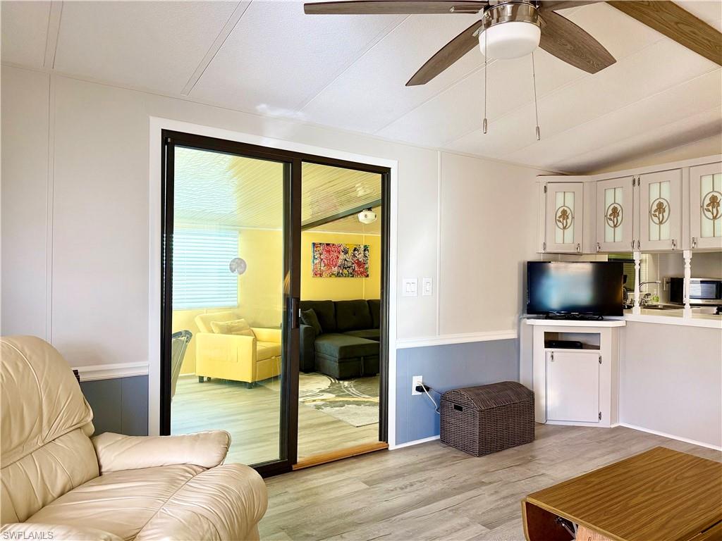 16 Bass Lane, Unit 16 Naples, FL 34114 - Photo 16 of 45 a living room with furniture and a flat screen tv