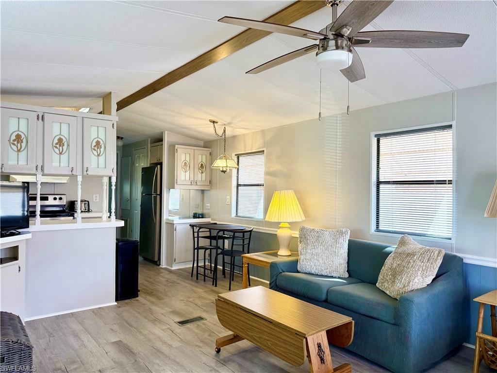 16 Bass Lane, Unit 16 Naples, FL 34114 - Photo 17 of 45 a living room with furniture and a wooden floor