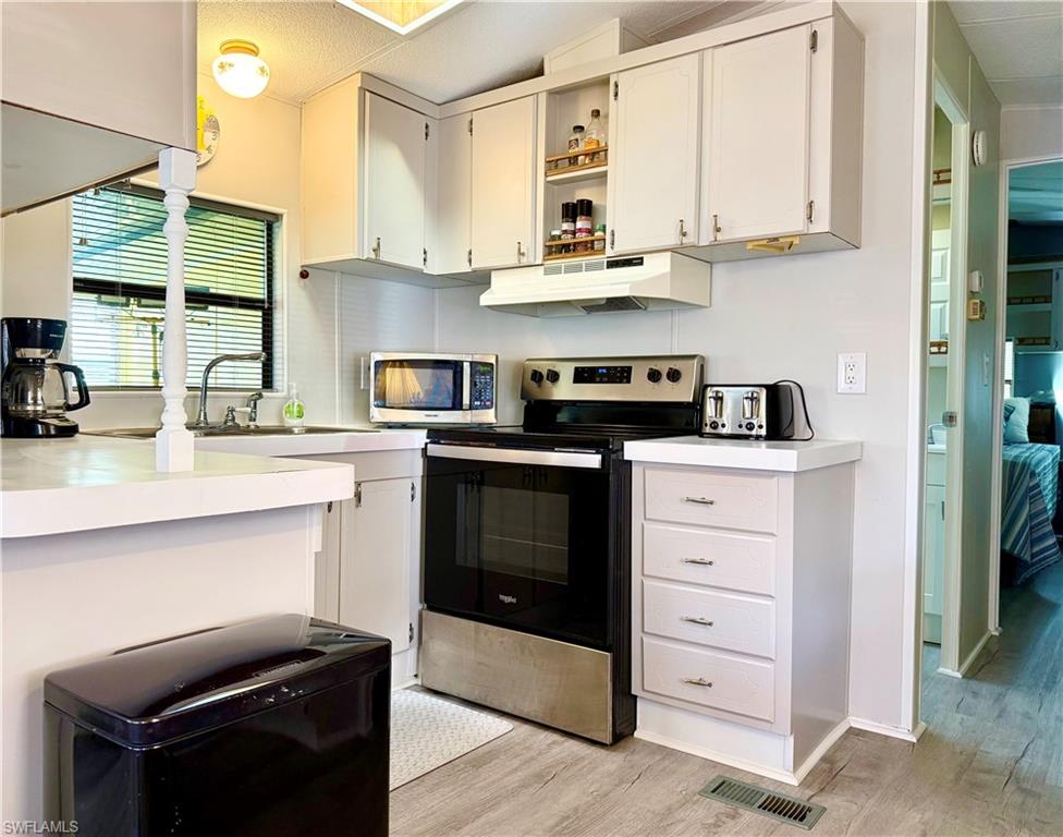 16 Bass Lane, Unit 16 Naples, FL 34114 - Photo 18 of 45 a kitchen with stainless steel appliances granite countertop a stove and a sink