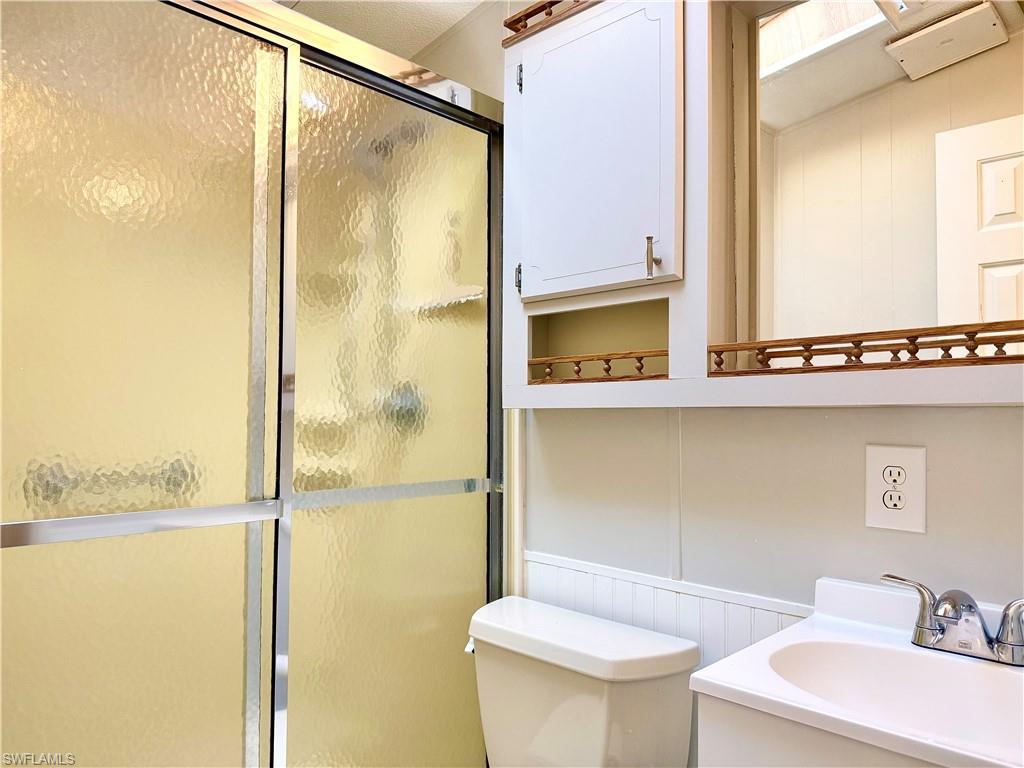 16 Bass Lane, Unit 16 Naples, FL 34114 - Photo 20 of 45 a bathroom with a sink and a mirror